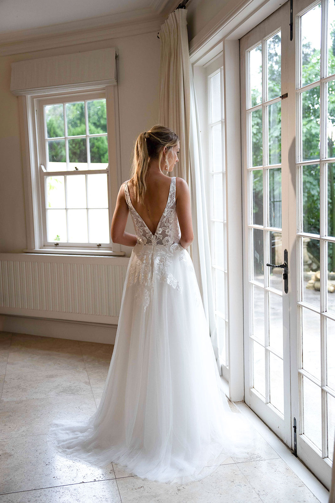 Open V Back Design of Ivory White A-line Wedding Gown with V Neckline adorned with Lace Appliques, Sheer Bodice and Full Voluminous Layered Tulle Skirt
