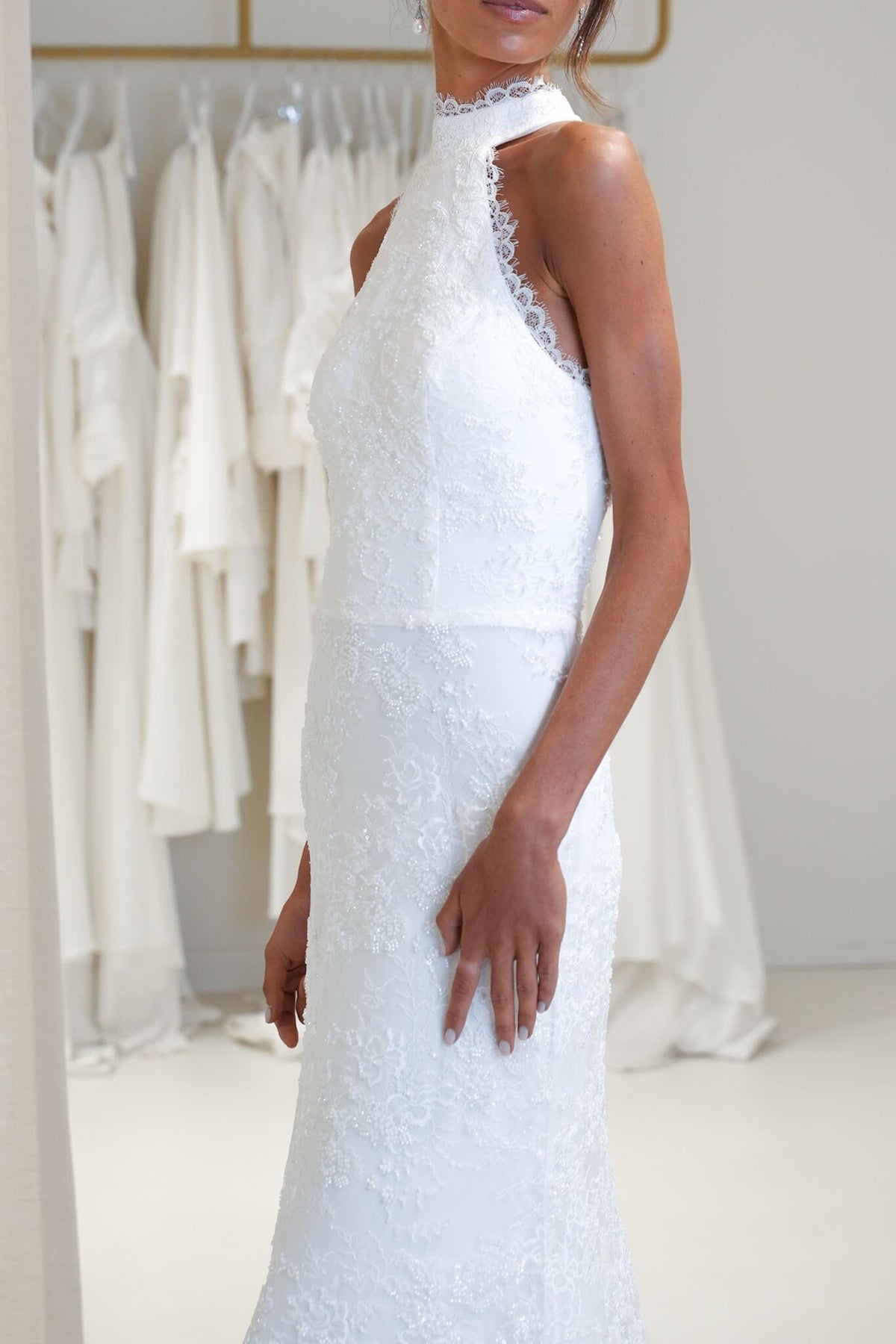 Close Up Image of Ivory White High Neck Beaded Lace Wedding Gown with Lace Trim Detail