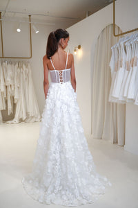 Back image of bride wearing a Francine 3D floral wedding dress featuring sheer bodice and lace up back