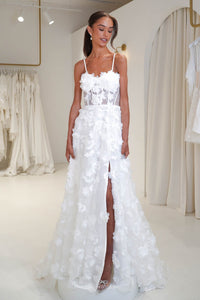 Young bride wearing the Francine 3D floral wedding dress in Noodz Boutique bridal shop