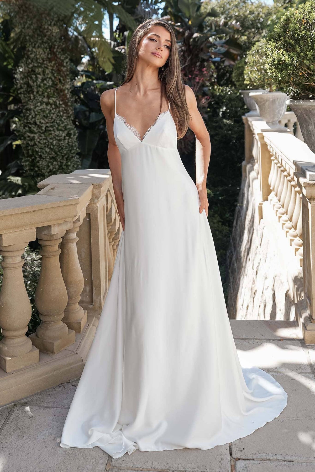 ROSITA ivory elopement wedding dress featuring a lace-trimmed V-neckline, spaghetti straps and flowing A-line silhouette