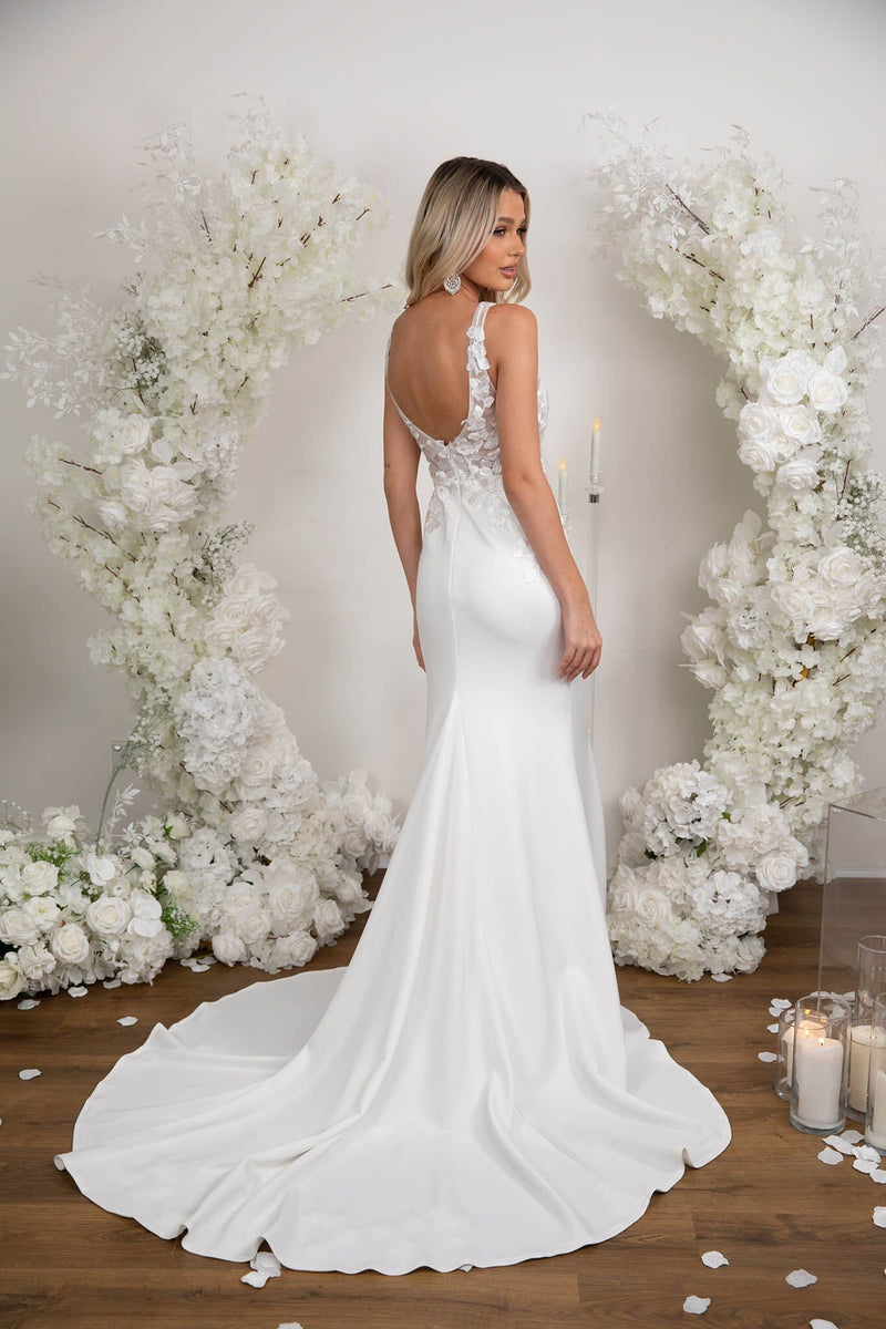 Open Back Design of Form Fitting Ivory White Wedding Gown with V Neck, Lace Motif Detailing, Open Back and Sweep Train