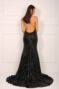 Backless design of black sequinned mermaid evening gown with halter v plunge neck and high centre front leg slit