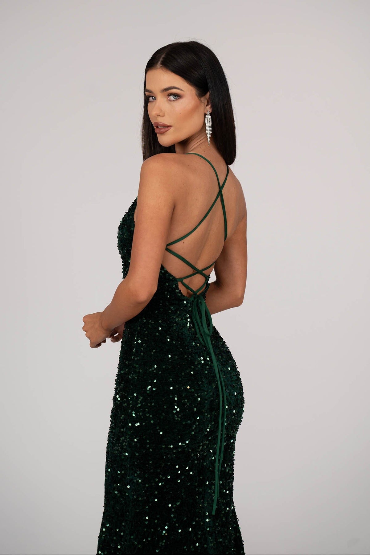 Close Up Image of Lace Up Open Back Design of Emerald Green Velvet Sequin Full Length Evening Gown with V Neckline, Thin Shoulder Straps and Thigh High Side Split